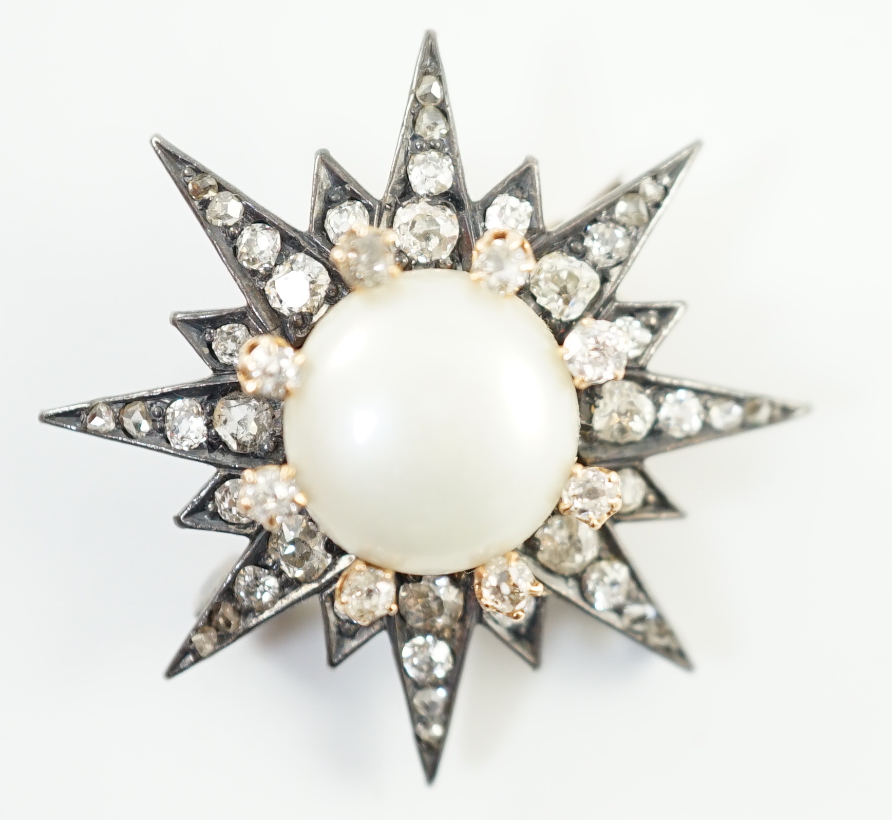 A Victorian gold and silver, button pearl and graduated round and rose cut diamond set cluster starburst brooch